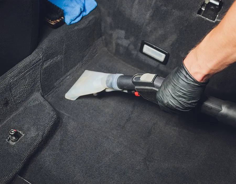 OCD technician steam-extracting and deep-cleaning vehicle carpet